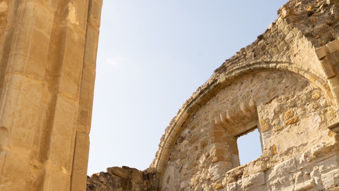 Ancient stone ruins under a clear blue sky.